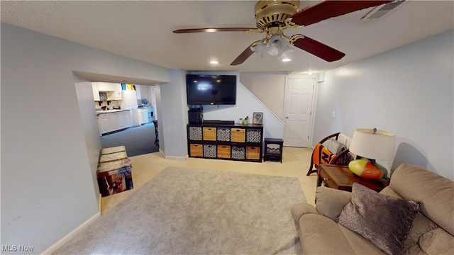 living room featuring ceiling fan and light colored carpet