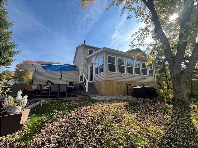 back of property with a wooden deck