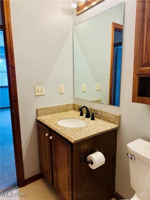 bathroom with tile patterned floors, vanity, and toilet