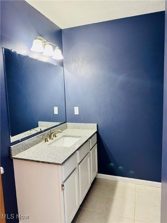 bathroom with tile patterned flooring and vanity