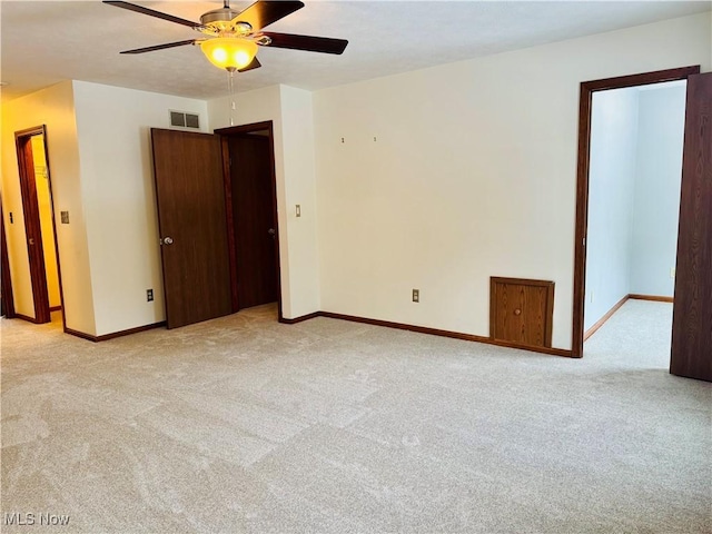 carpeted empty room featuring ceiling fan