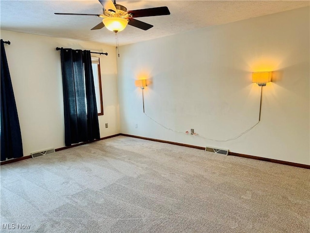 carpeted spare room with ceiling fan