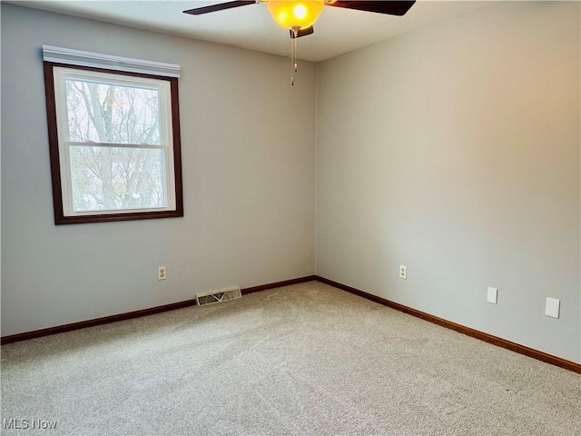 carpeted empty room featuring ceiling fan