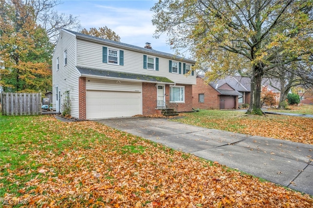 view of front of property featuring a garage and a front lawn