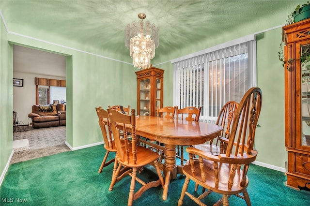 dining space featuring a chandelier and dark carpet