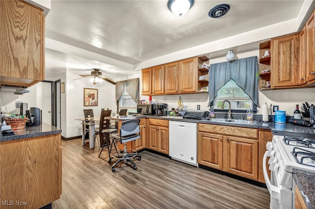 kitchen with sink, white appliances, wood-type flooring, and ceiling fan