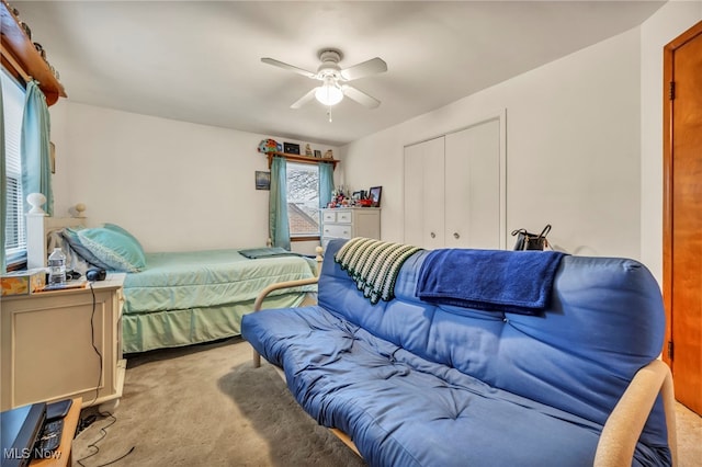 bedroom with ceiling fan, a closet, and light colored carpet