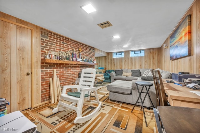 living room with wood walls and brick wall