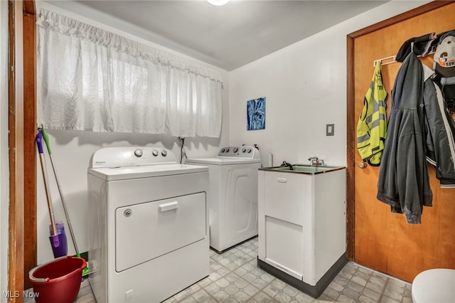 laundry room featuring sink and washer and clothes dryer