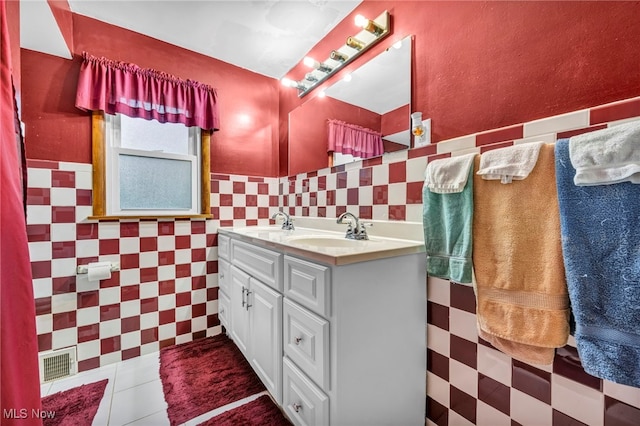 bathroom featuring tile walls, tile patterned flooring, and vanity