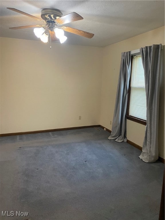 carpeted empty room featuring a textured ceiling and ceiling fan