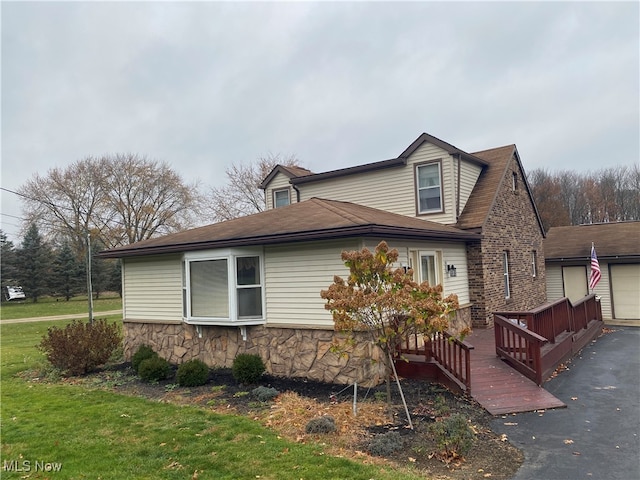 view of side of property with a lawn and a deck