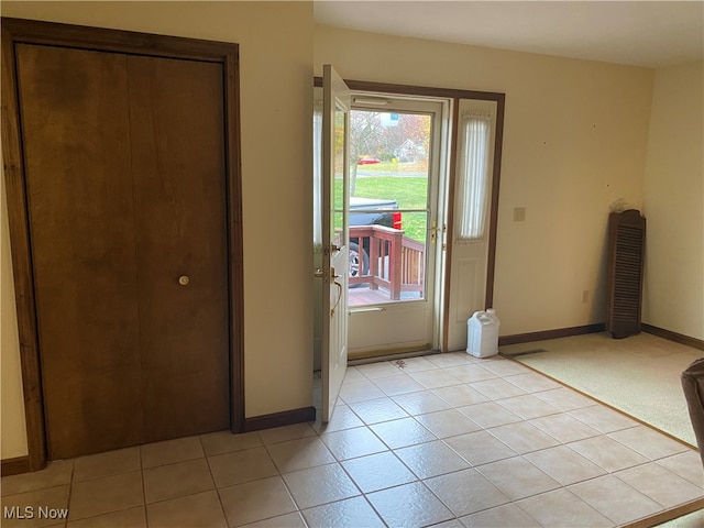 doorway to outside with light tile patterned floors