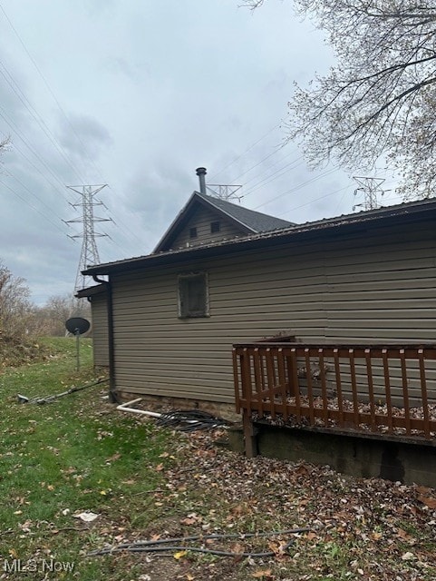 view of side of property featuring a deck