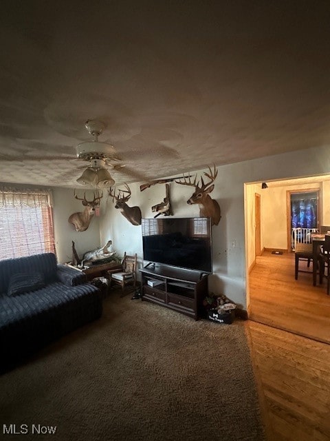 living room featuring hardwood / wood-style flooring and ceiling fan