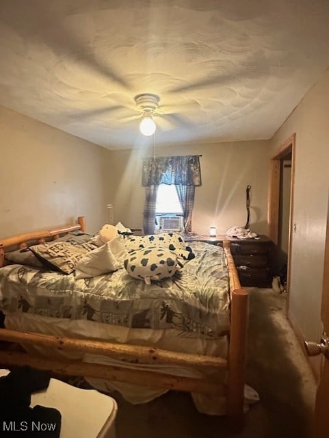 bedroom featuring ceiling fan, cooling unit, and carpet flooring