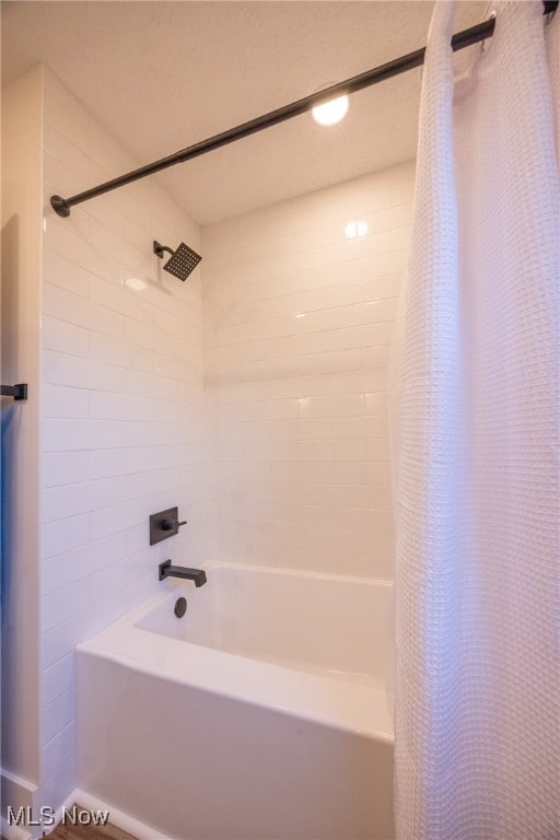 bathroom with shower / bathtub combination with curtain