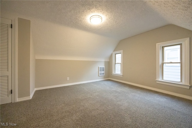 bonus room featuring carpet, plenty of natural light, a textured ceiling, and vaulted ceiling