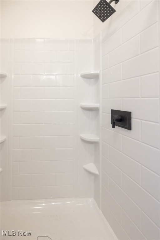 bathroom with tiled shower