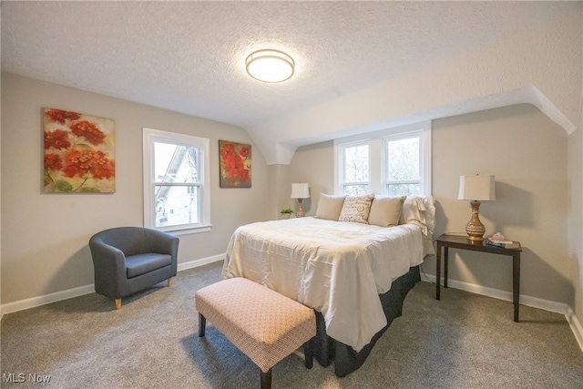 carpeted bedroom featuring a textured ceiling and vaulted ceiling