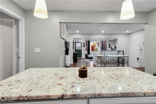 kitchen featuring dark hardwood / wood-style floors and decorative light fixtures