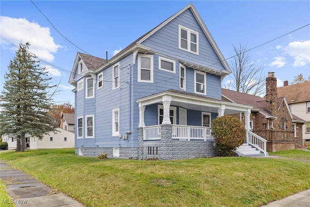 view of front of property with covered porch and a front yard