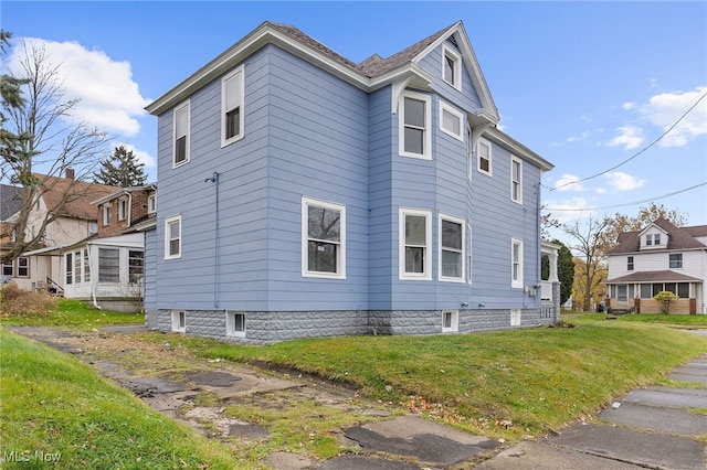 view of property exterior featuring a lawn