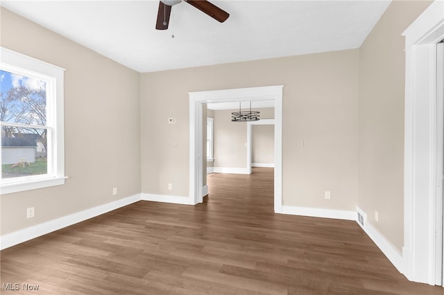 empty room featuring ceiling fan and dark hardwood / wood-style floors