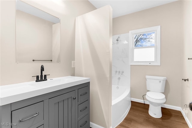 full bathroom with toilet, vanity, hardwood / wood-style floors, and  shower combination