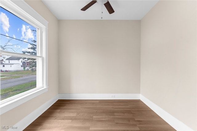 empty room with hardwood / wood-style flooring and ceiling fan