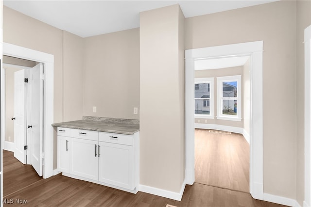 interior space featuring white cabinets and dark hardwood / wood-style flooring