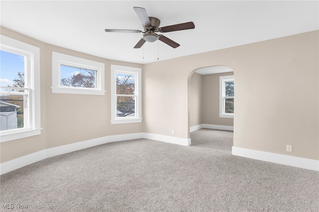 carpeted empty room featuring ceiling fan