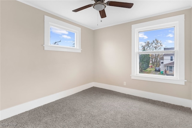 carpeted empty room with ceiling fan and ornamental molding