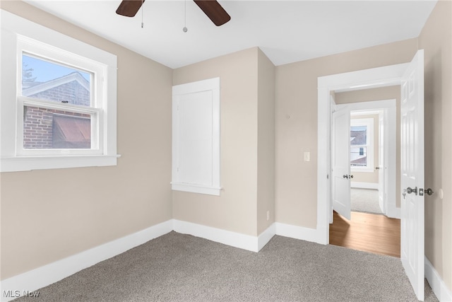 empty room with carpet flooring and ceiling fan