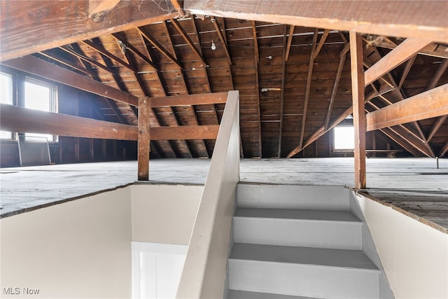 stairway featuring vaulted ceiling