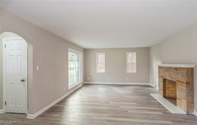 unfurnished living room with a fireplace and light hardwood / wood-style flooring