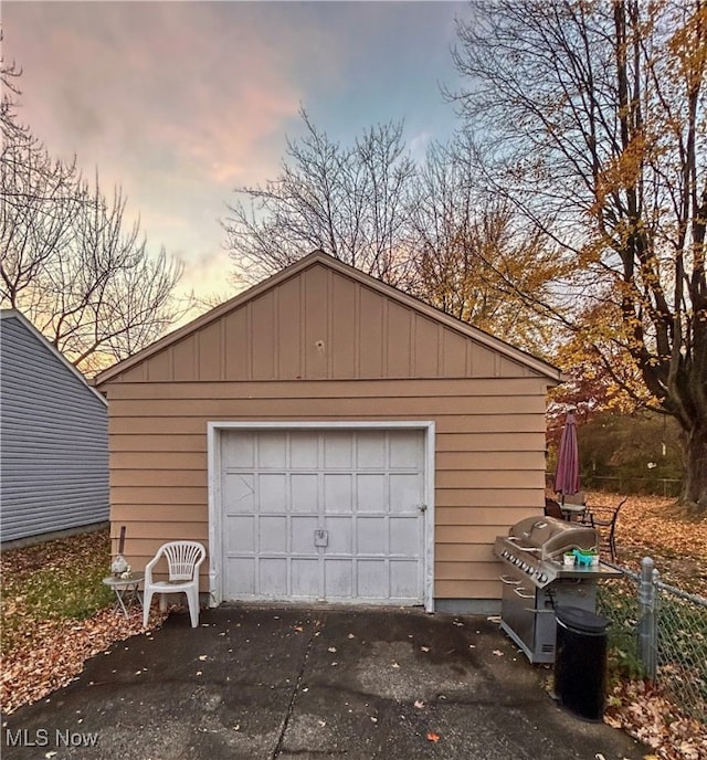 view of garage at dusk