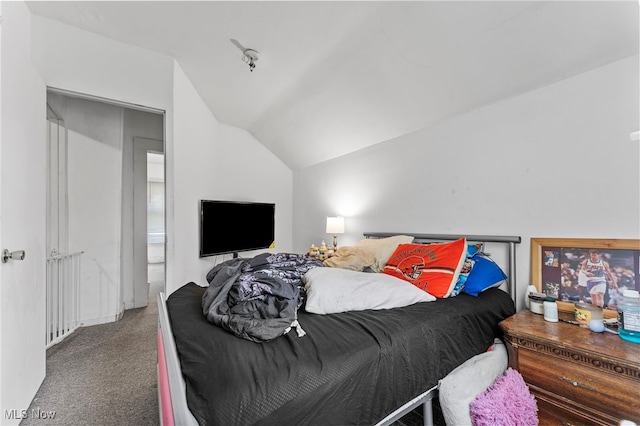 carpeted bedroom with lofted ceiling