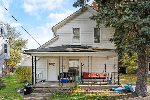 back of house featuring a porch