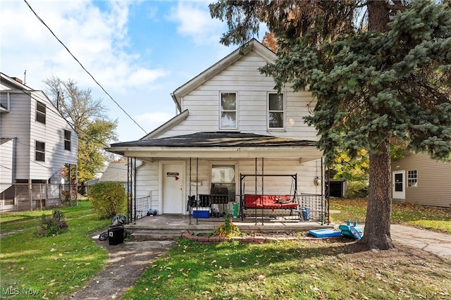 view of front facade with a front lawn and covered porch