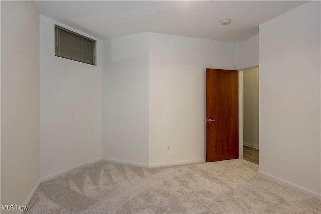 unfurnished room with light colored carpet