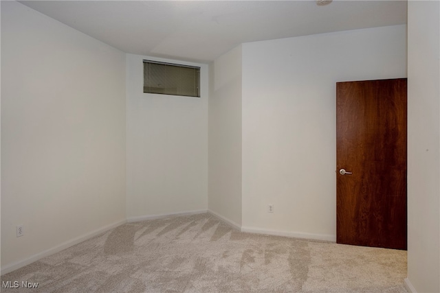 empty room featuring light carpet