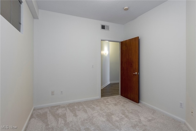 spare room with light carpet