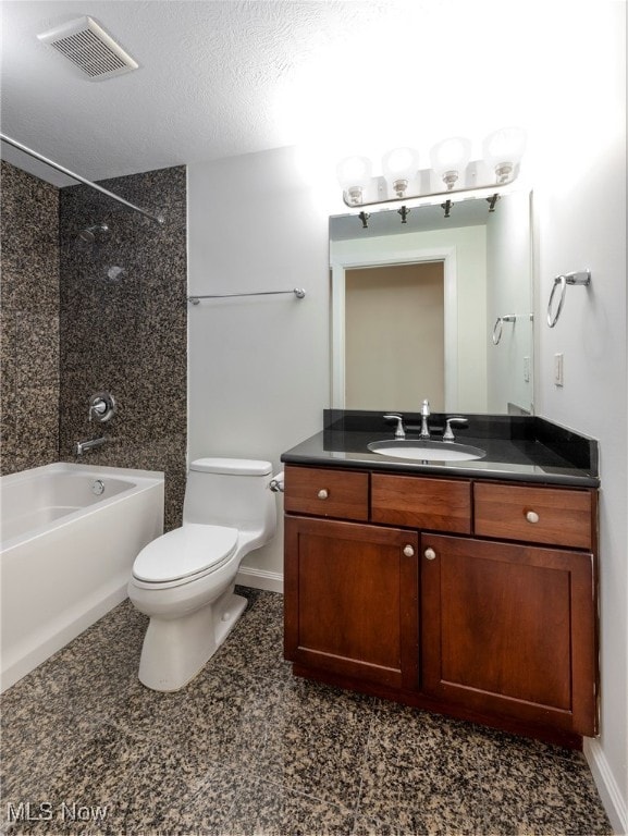 full bathroom with toilet, vanity, a textured ceiling, and tiled shower / bath