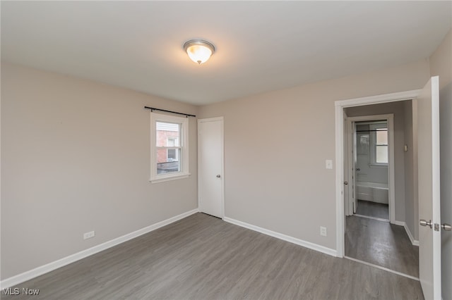 unfurnished room with wood-type flooring