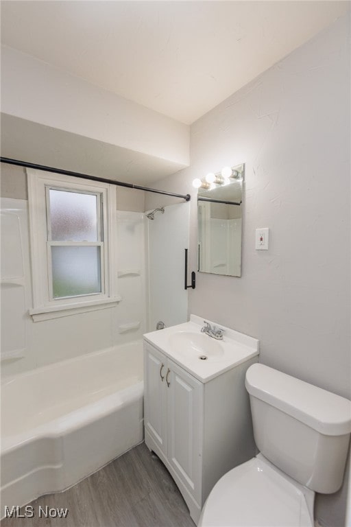 full bathroom with hardwood / wood-style floors, vanity, toilet, and bathtub / shower combination