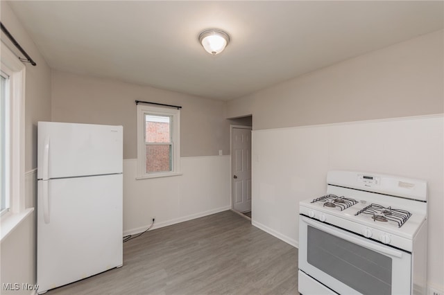 kitchen featuring light hardwood / wood-style flooring and white appliances