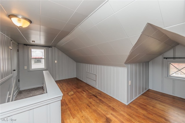 bonus room with vaulted ceiling and hardwood / wood-style flooring