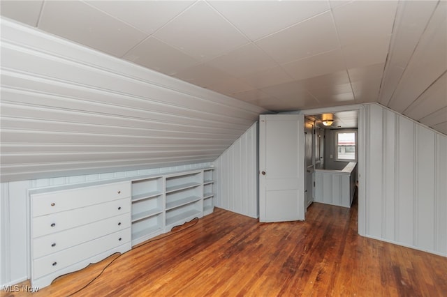 bonus room with dark hardwood / wood-style floors and vaulted ceiling