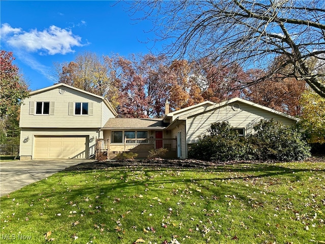 view of front of property with a garage and a front yard